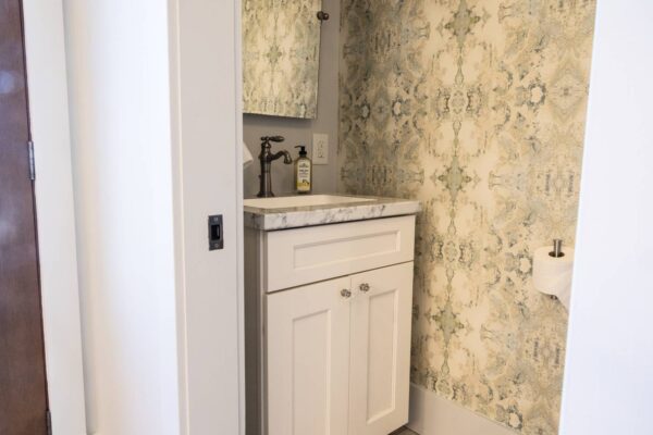 A small bathroom featuring a sink and a mirror, showcasing a compact and functional design